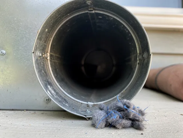 New Britain Dryer Vent Cleaning technician using specialized equipment to clear severe dryer vent blockage in New Britain